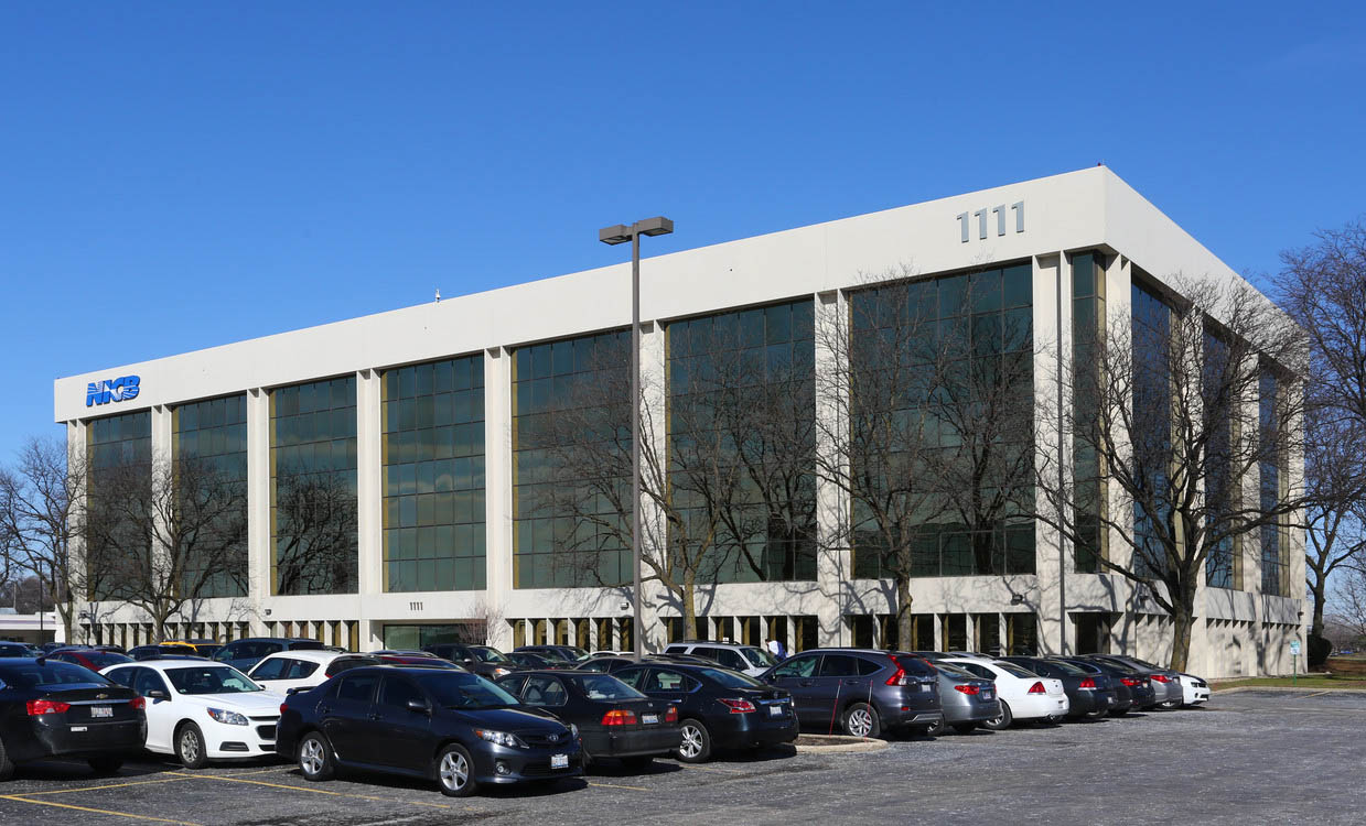 Street view of a corporate office space with a parking lot - Cawley Commercial Real Estate