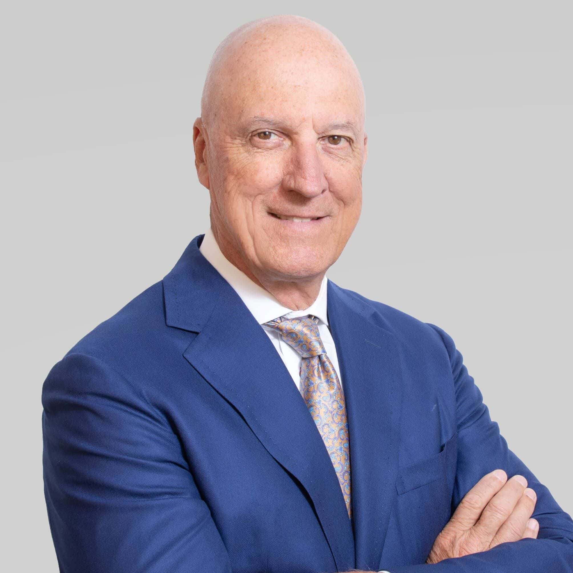 Professional portrait of Daniel Cawley, SIOR, in a blue suit for real estate expertise.