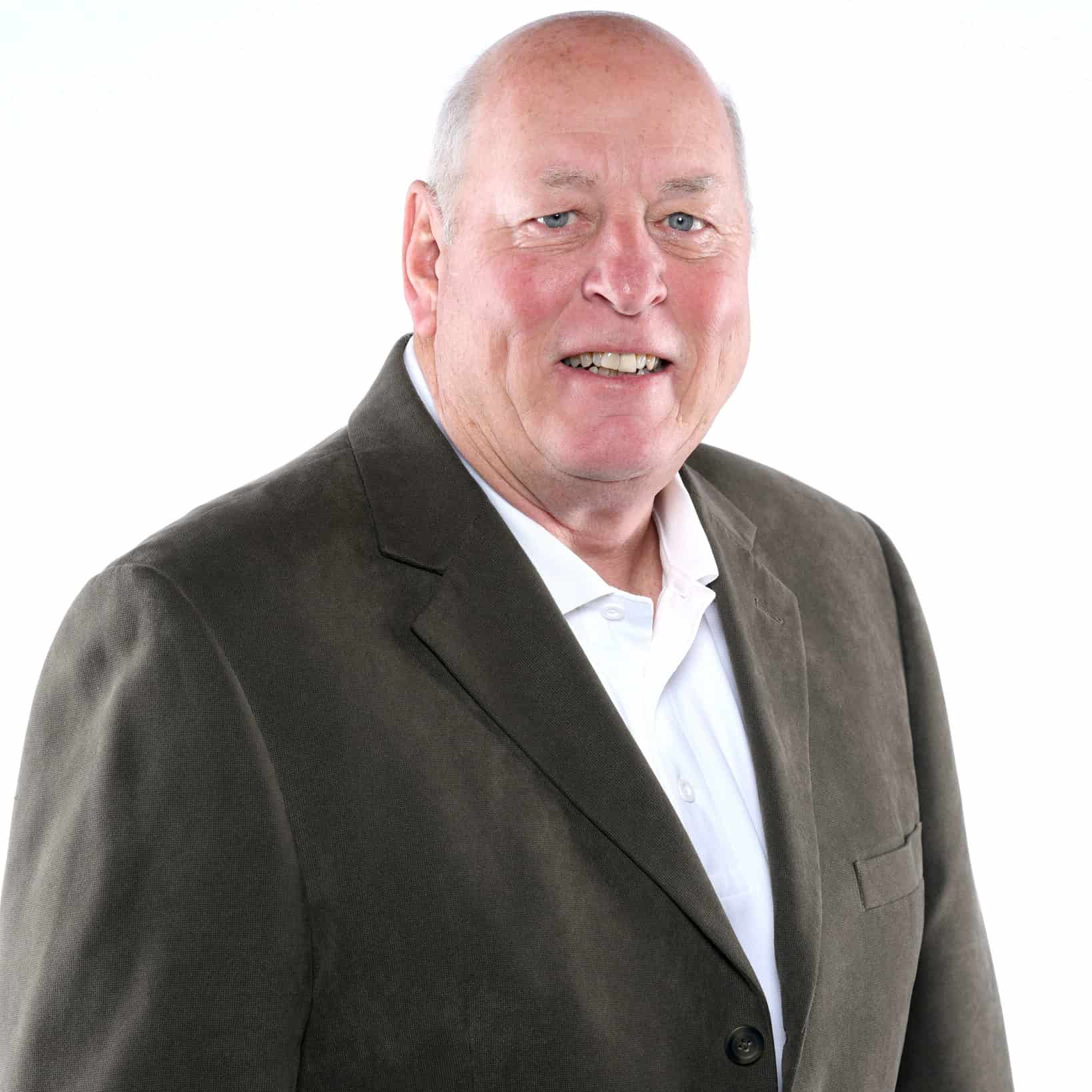 Professional portrait of Tim Gallagher, SIOR, in a suit for real estate expertise.