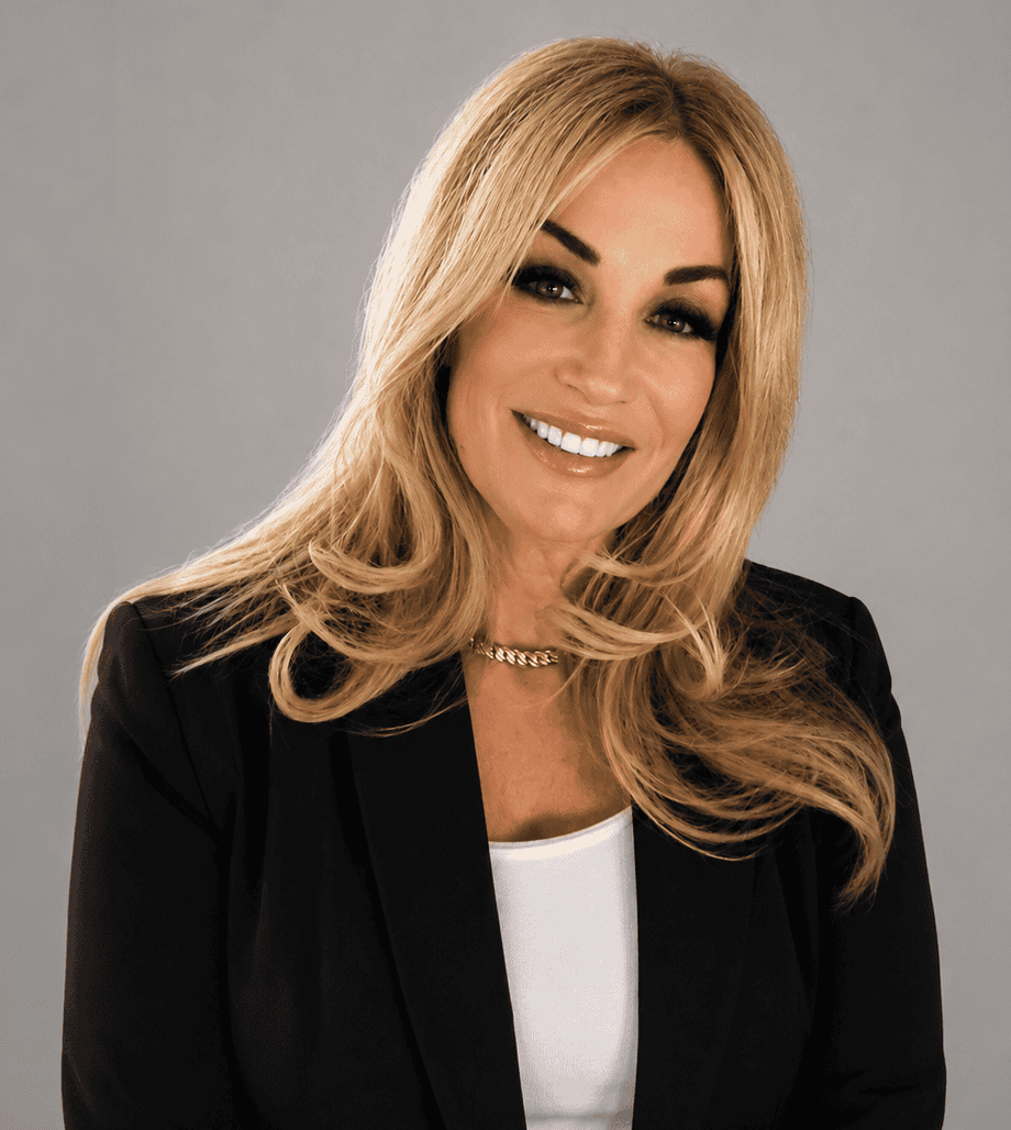 Professional woman in black blazer smiling for business portrait.