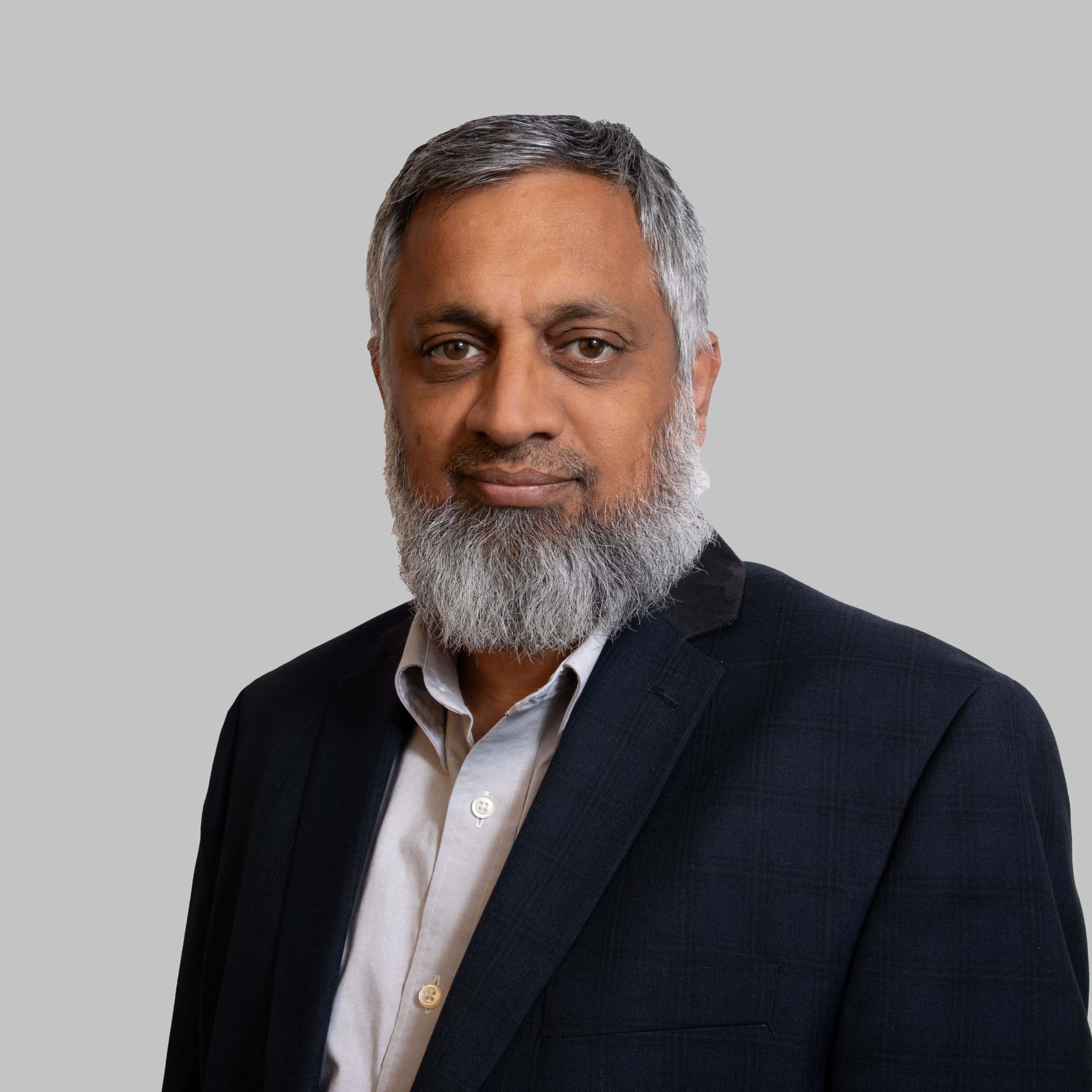 Portrait of Nisar Umrani in formal attire for professional profile.
