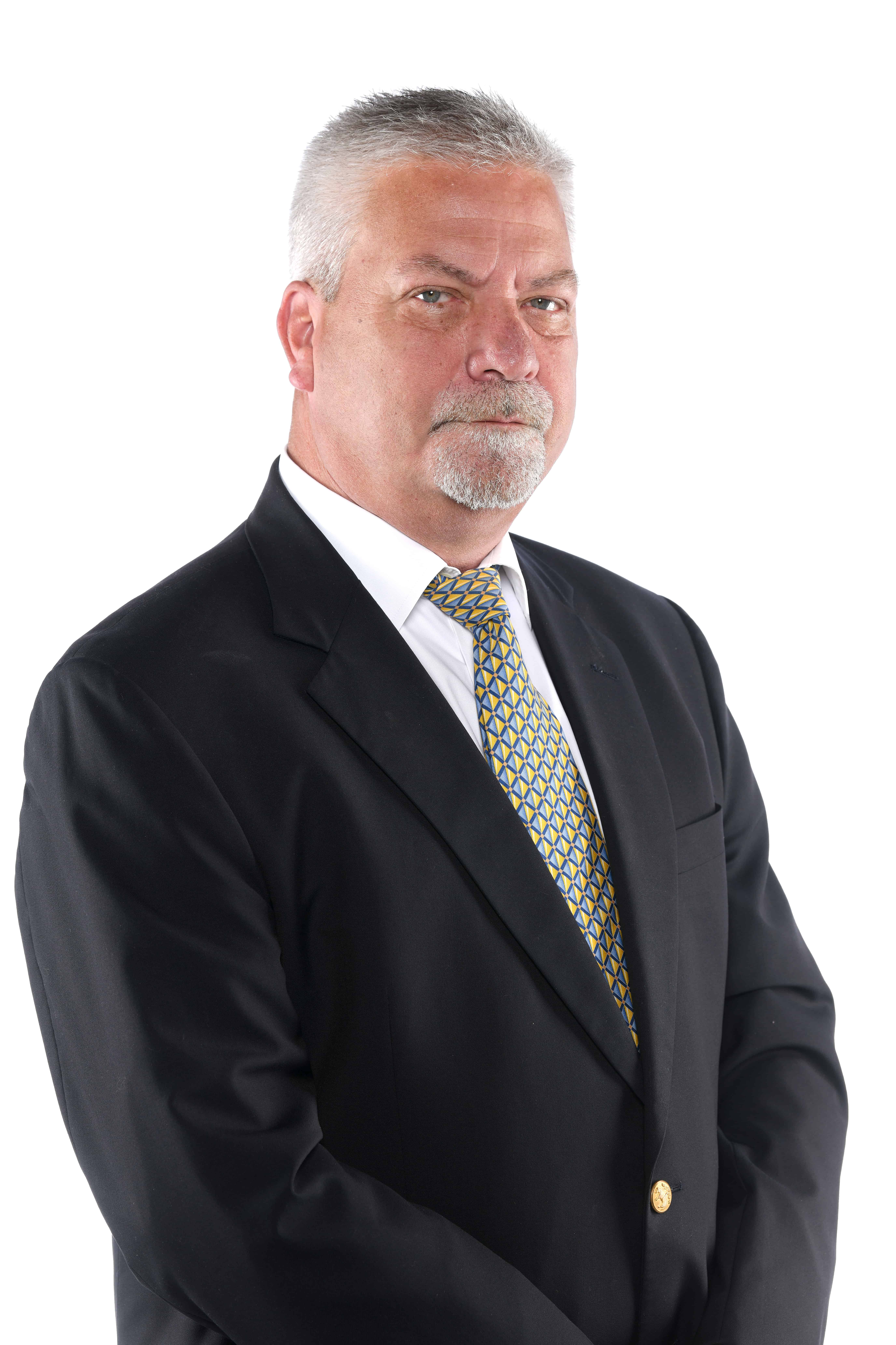 Professional senior man in a black suit with a serious expression.