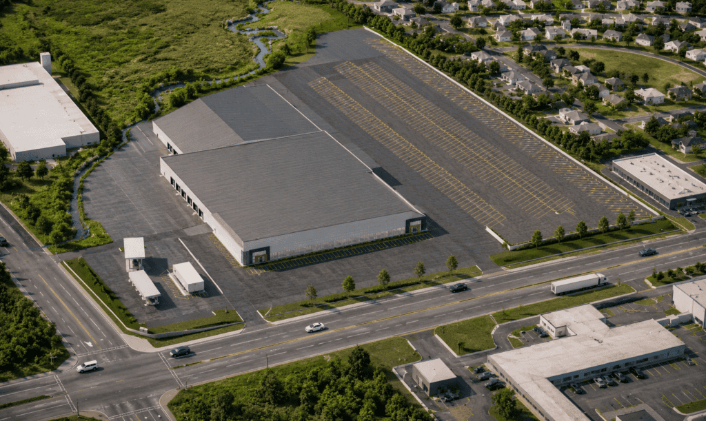 Aerial view of a large industrial warehouse with parking and surrounding roads.